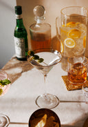Alcohol bottles and cocktails on a marble surface