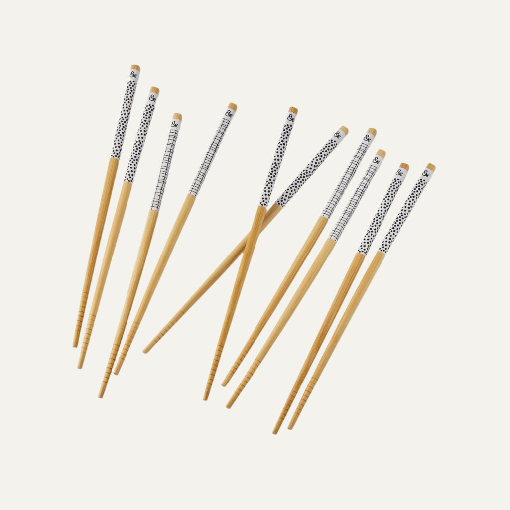A set of 10 bamboo chopsticks with a decorative dot and cross hatch handle design.